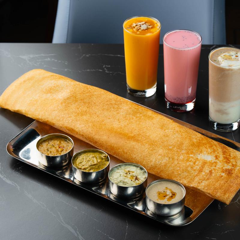 Dosa crepe, with various spreads and drinks.