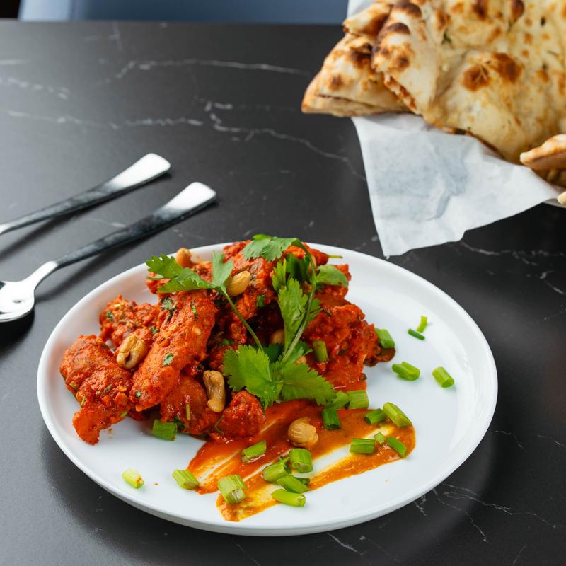 Marinated fish with herbs and naan bread.